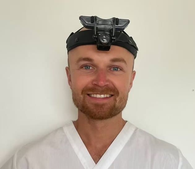 George Mustoe, Ear Care Practitioner, wearing examination head loupes